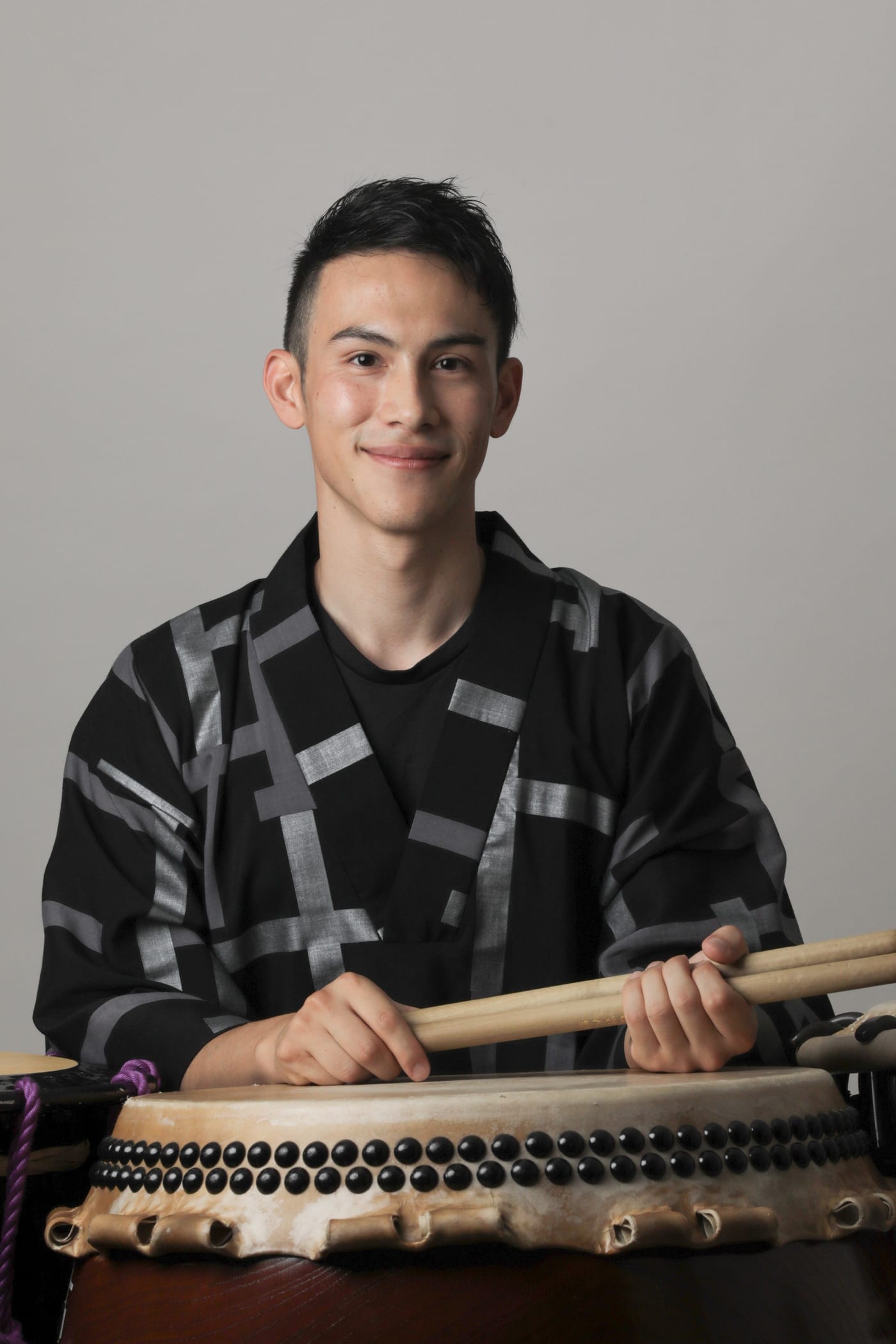 Sho’on Shibata smiling with bachi at a taiko